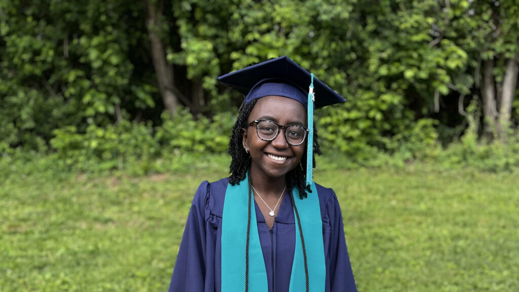2026 Holt adoptee graduate in mortar board and gown