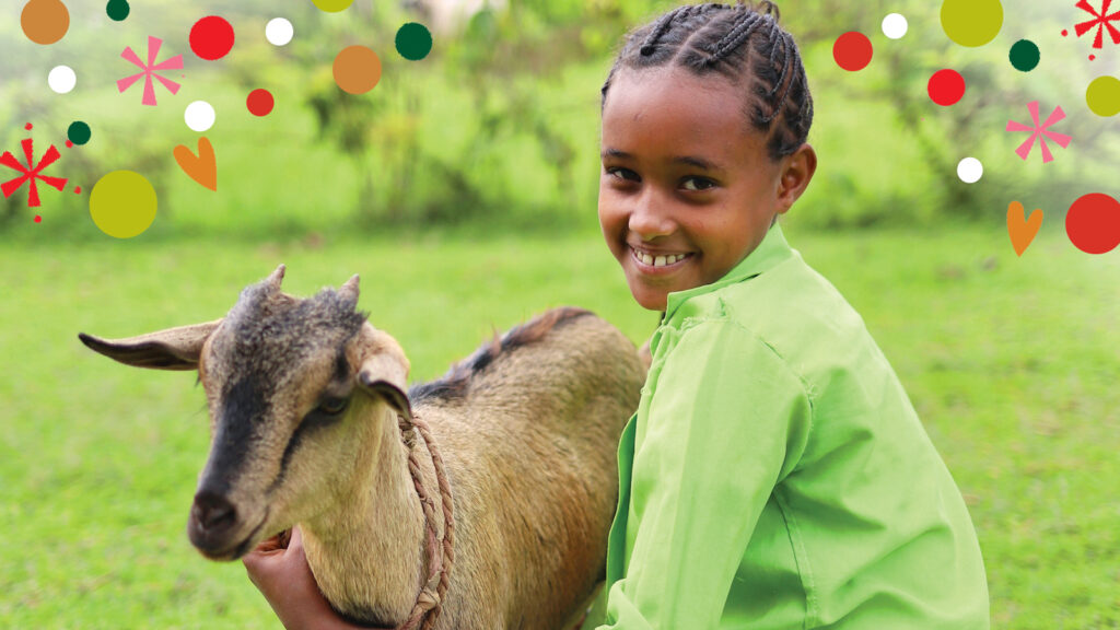 Young girl in Ethiopia hugging her goat