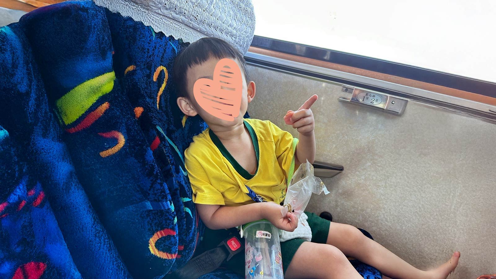 a child sits on a train, waiting for an adoptive family