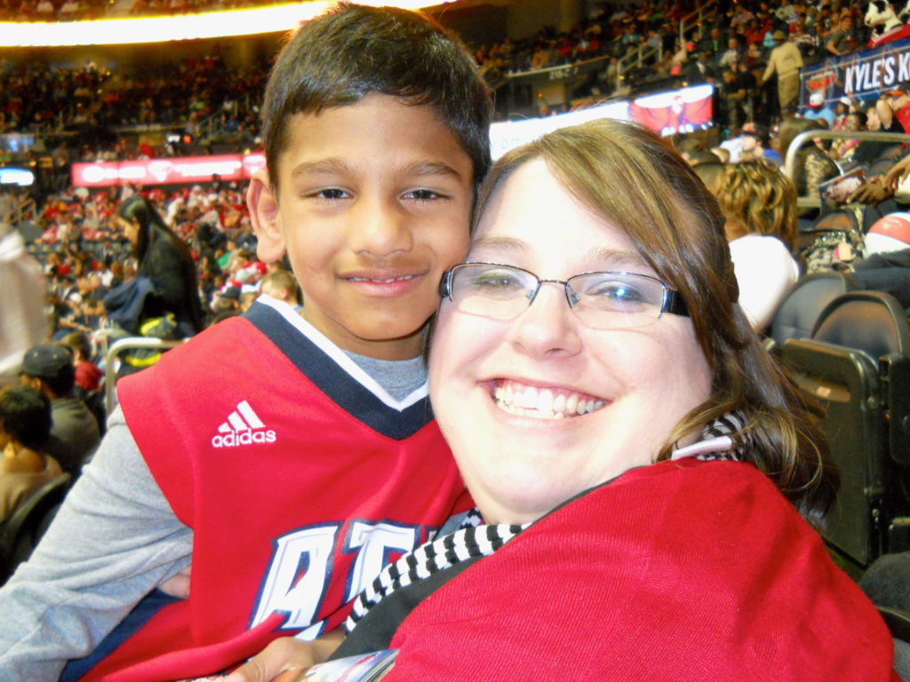 Abraham enjoys an NBA basketball game with his mom, Jamie.  