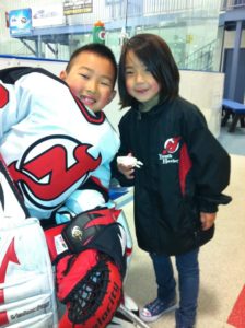 Jake in his New Jersey Youth Devils hockey uniform, pictured with his sister, Chloe.