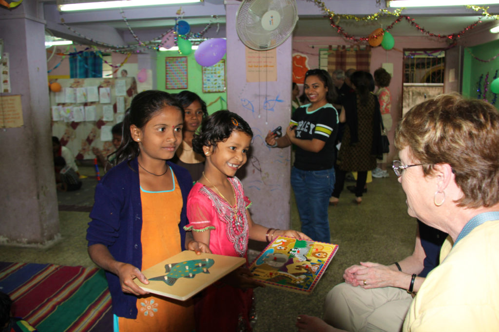 Children at BSSK share their projects with the vision trip participants.
