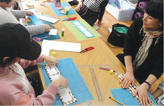 Women at the Holt Morning Garden shelter participate in an art therapy session, led by a local artist.