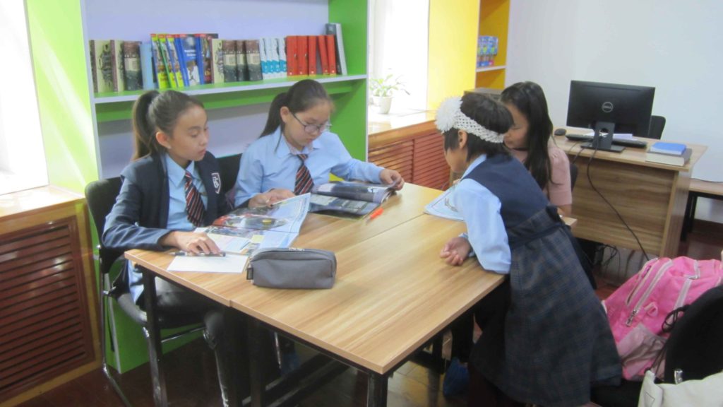 Girls sitting around desk