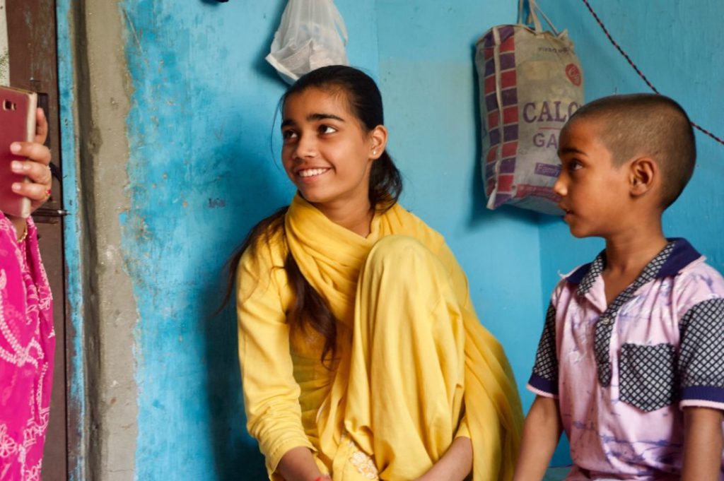 Two of Shabnam's children, one smiling and looking to the side
