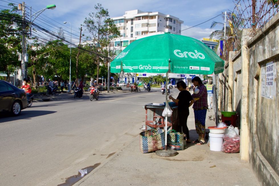 Linh and her mom work selling food at their roadside stand. 