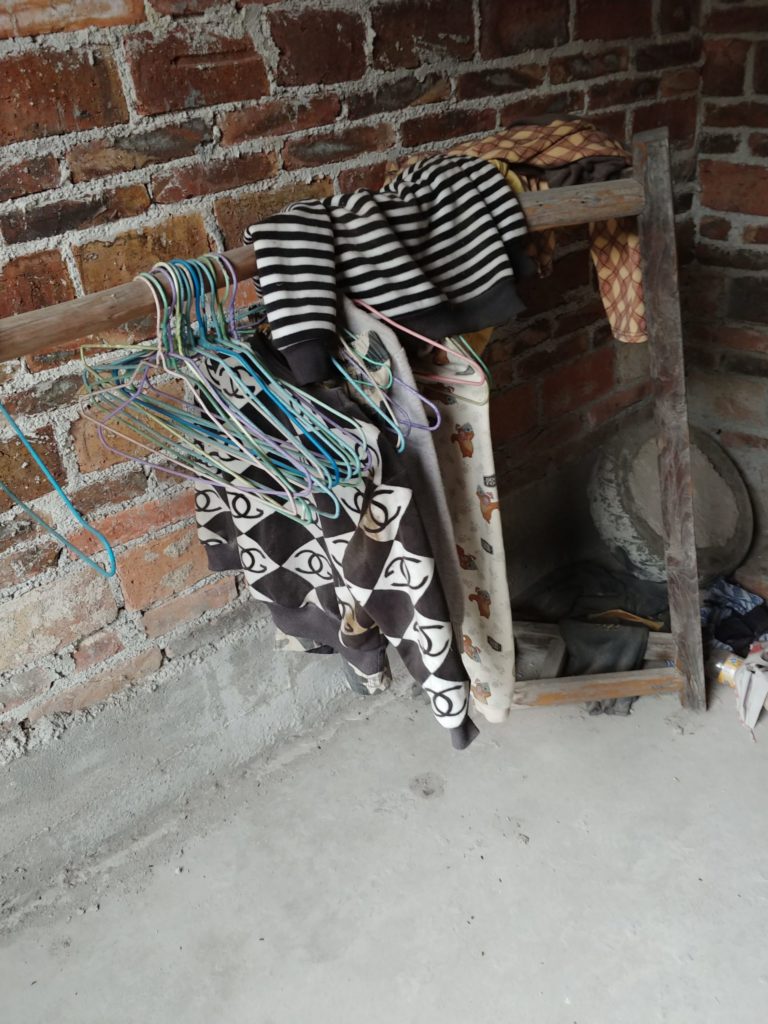 Some of Jenna's son's clothes. It has been kept preserved since he left to live in an HIV group home.