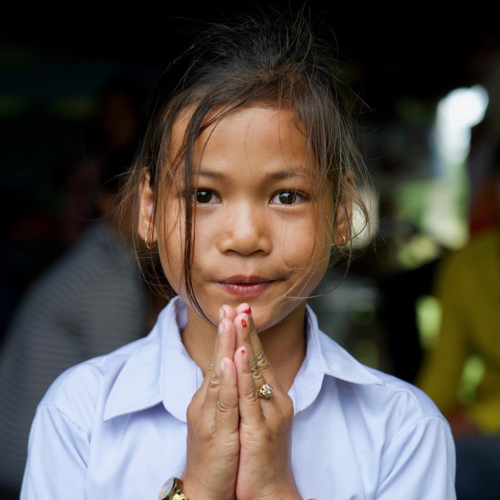 Sreyka holds her hands in a prayer gesture as she says thank you to her sponsor. 