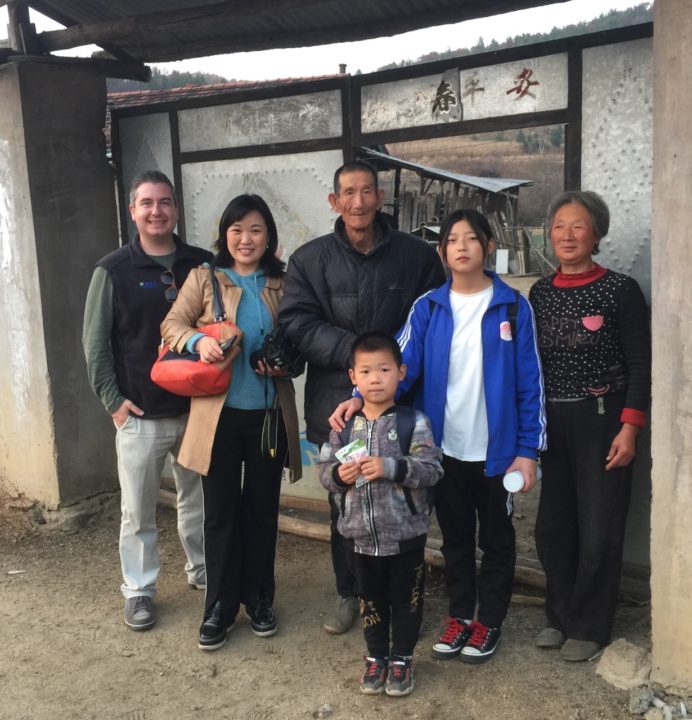 Luan with her grandparents, little brother, and two Holt staff members.