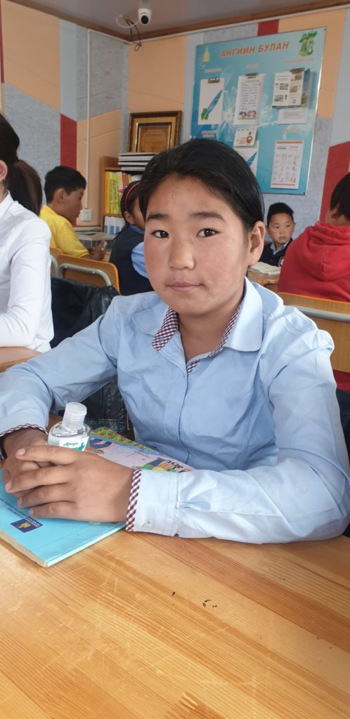 student with hand sanitizer