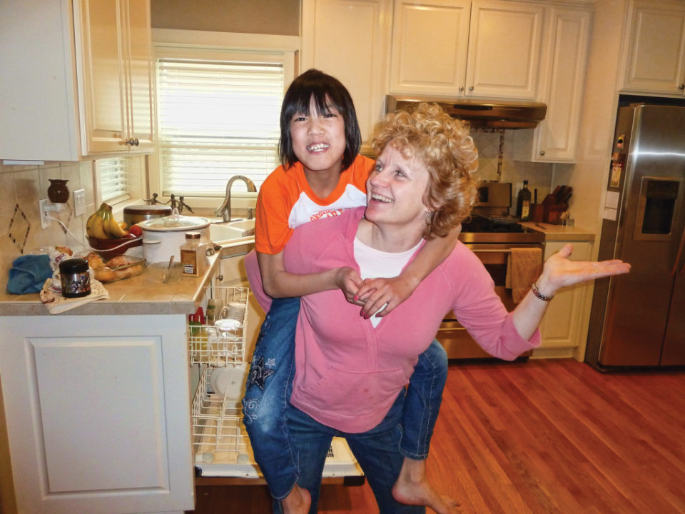 Adoptive mom Shila with her daughter Anna, who had a harder time attaching to her mom. “This was a wonderful moment where she let me put her on my back and dance around with her,” Shila says.