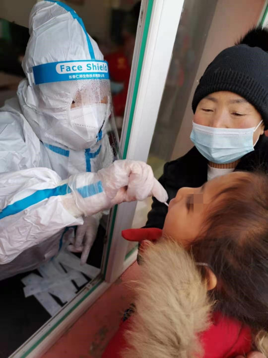 Children in Holt's China programs receive COVID tests. 