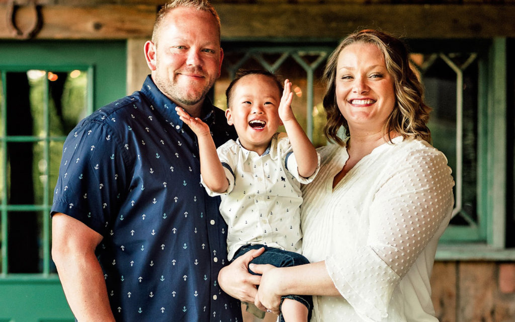 dad mom and son laughing and clapping