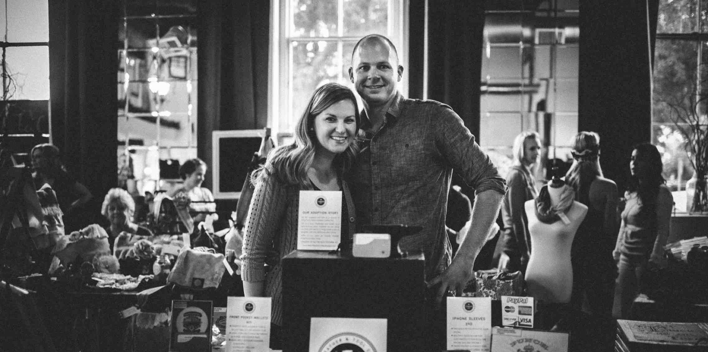 man with arm around woman at craft fair