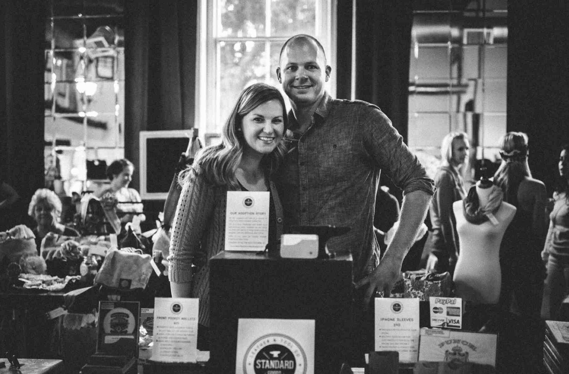 man with arm around woman at craft fair