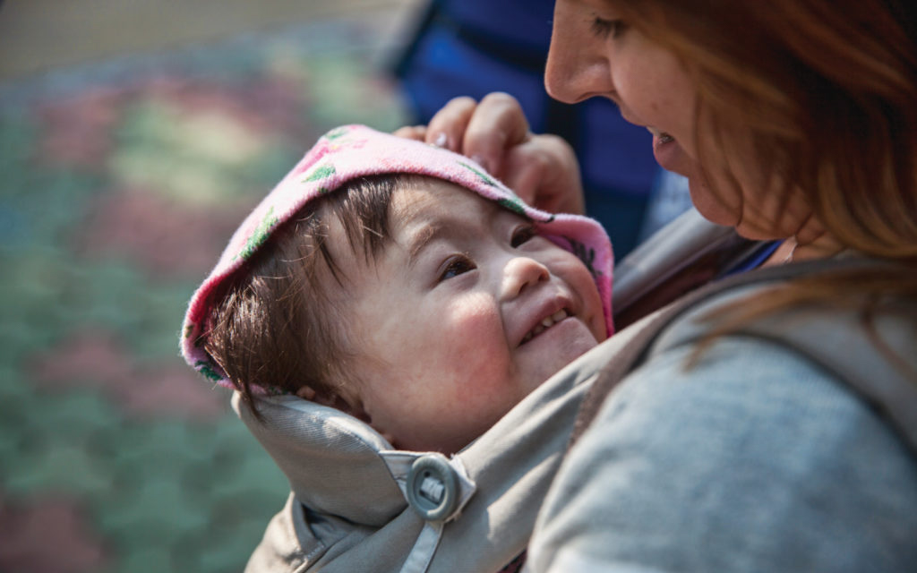 baby looking up at mom