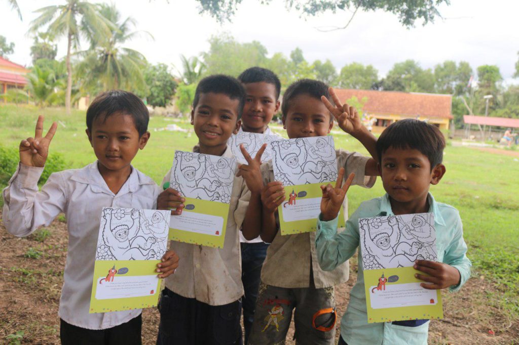five children smiling holding birthday cards