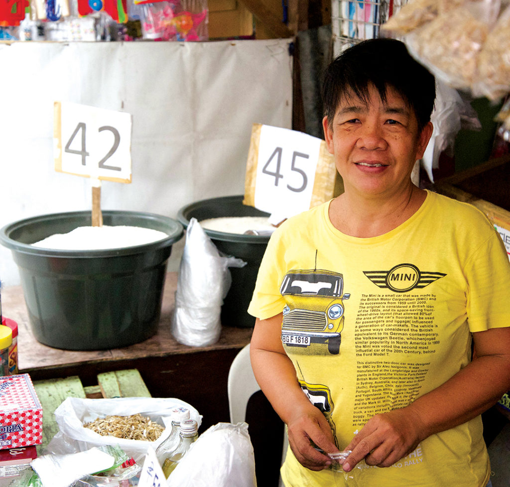 woman in yellow shirt at a smal shop
