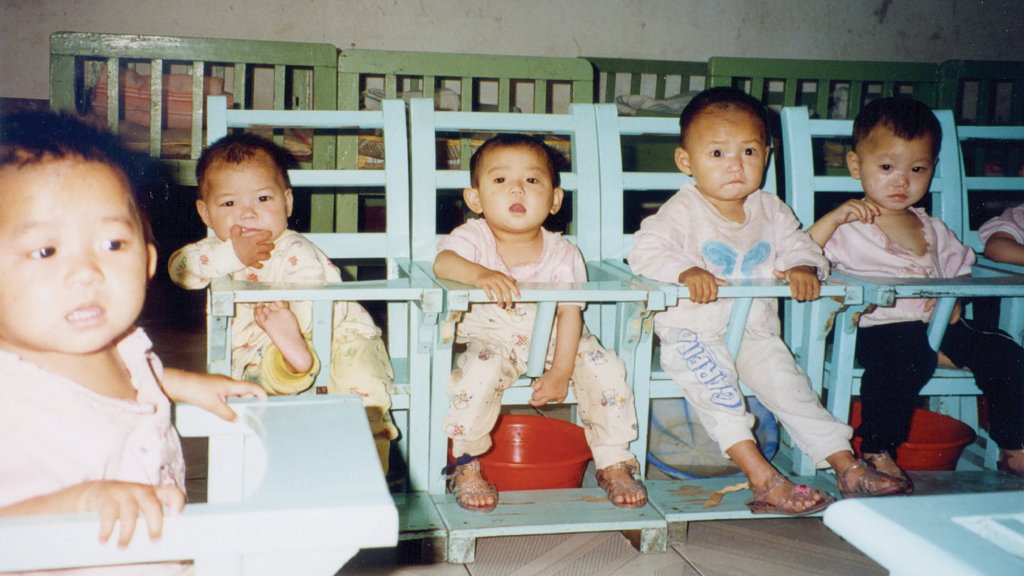 Children sit on pots in an orphanage in China in the 1990s.