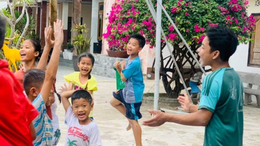 Children playing games outside in Vietnam