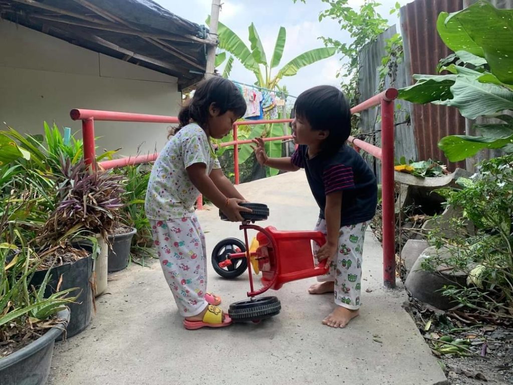 young boy and young girl playing outside