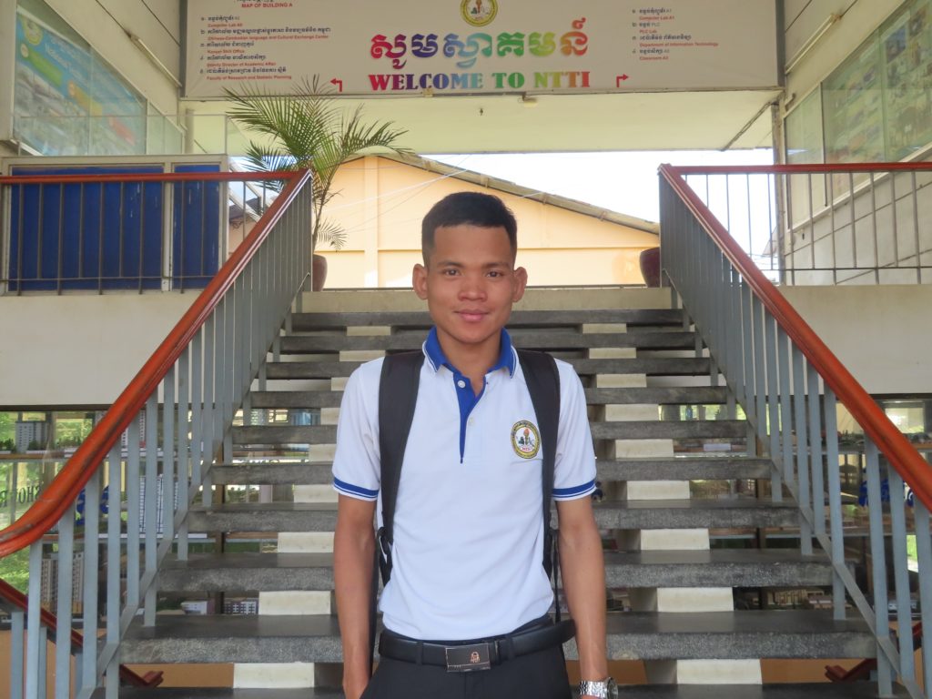 boy in university uniform smiling at camera