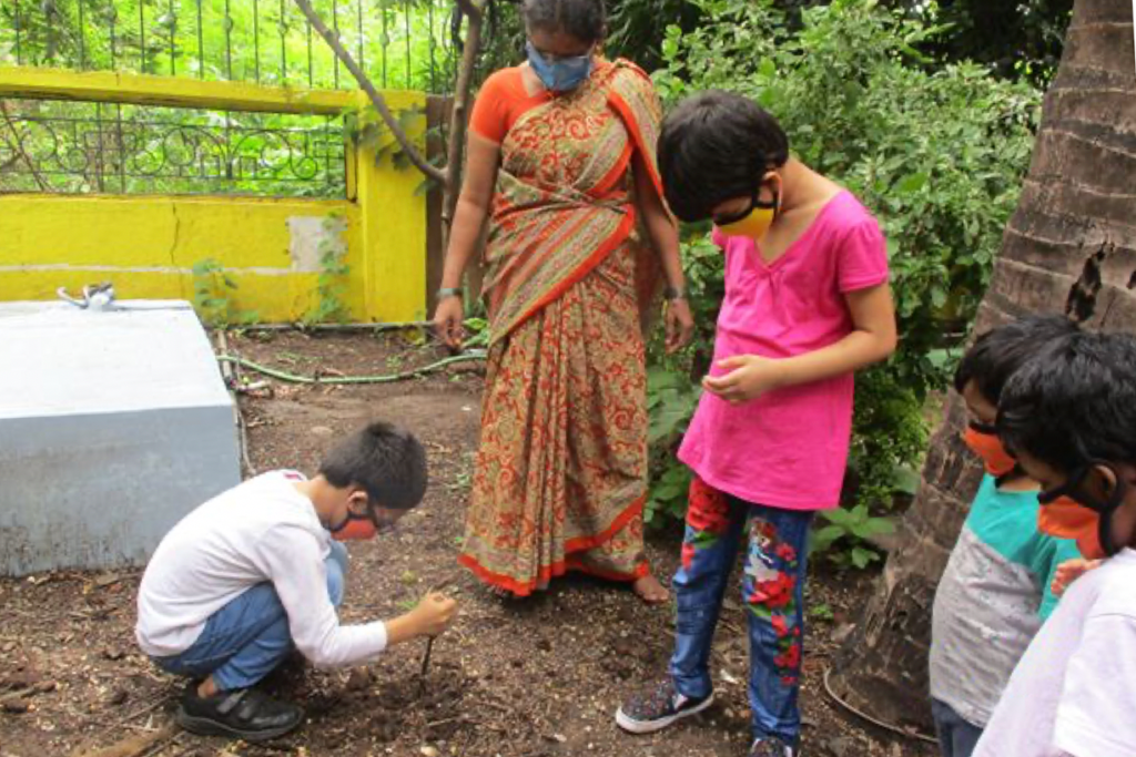 caregiver and children gardening