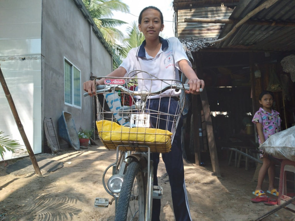 girl riding a bike towards the camera