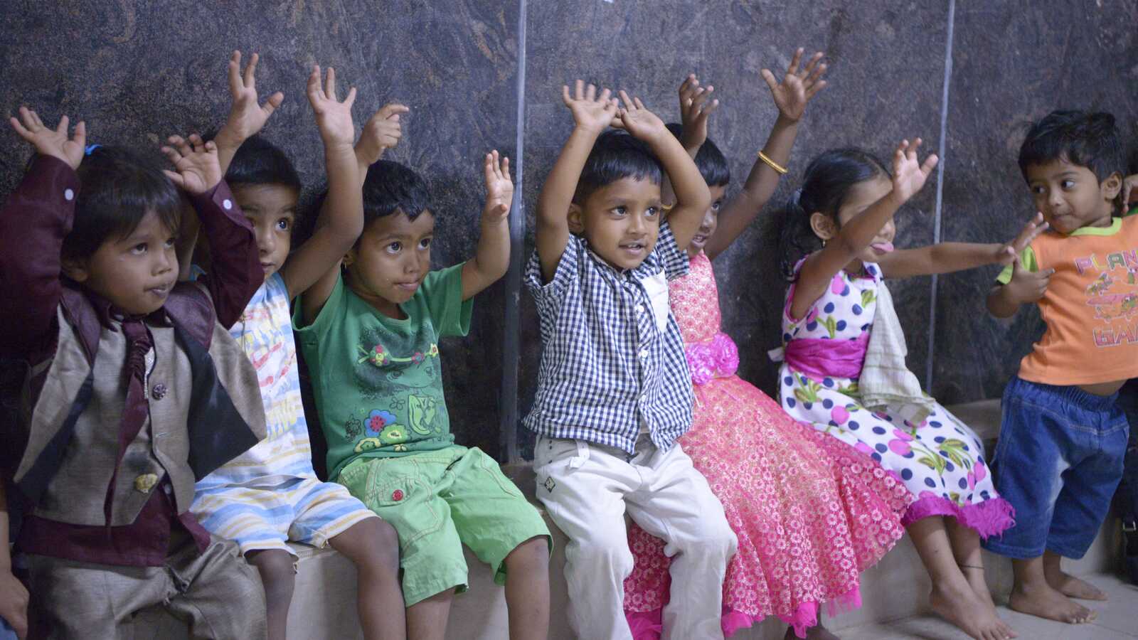 Children raising hands in India