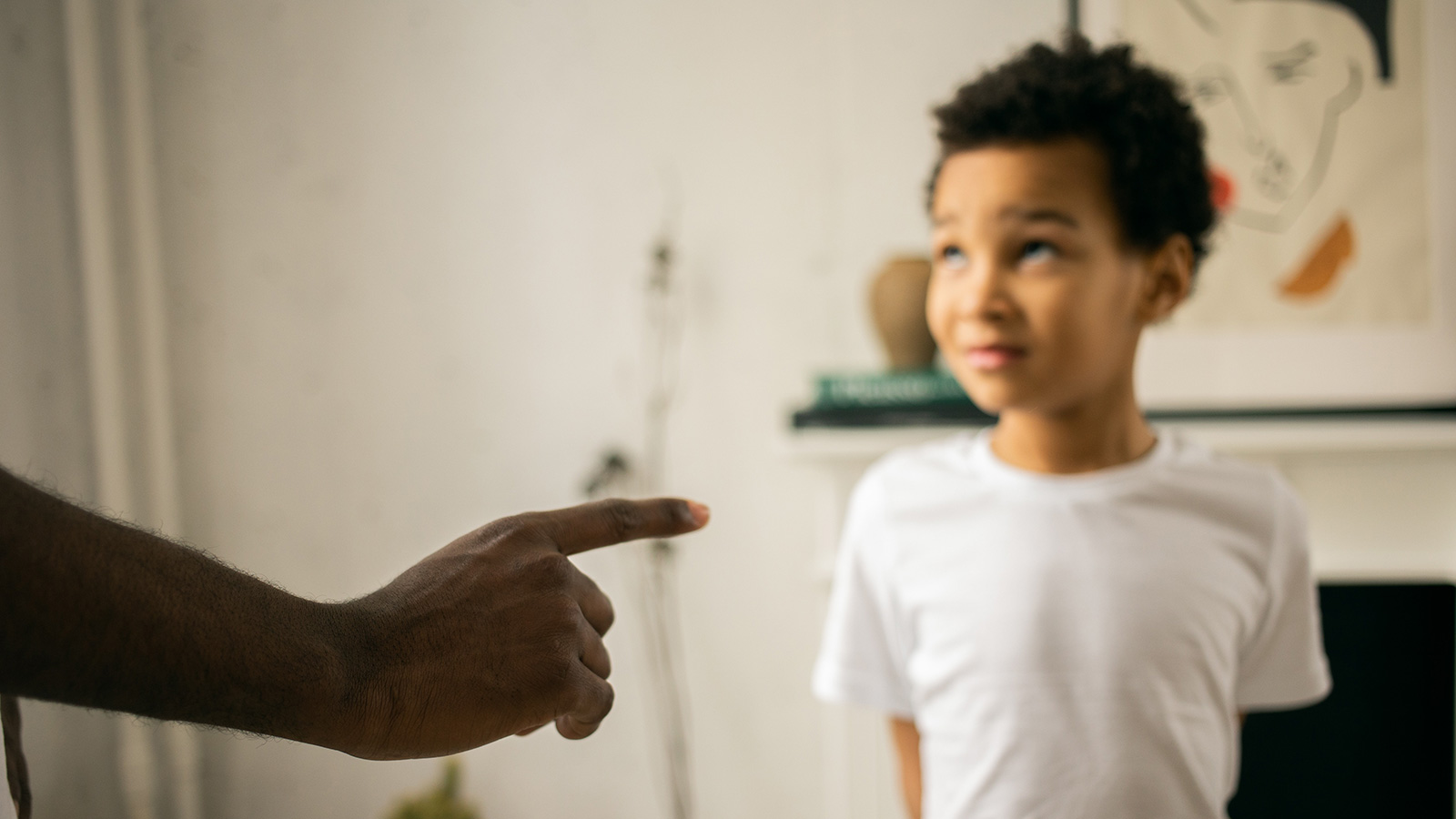 little boy receiving instructions from parent out of frame