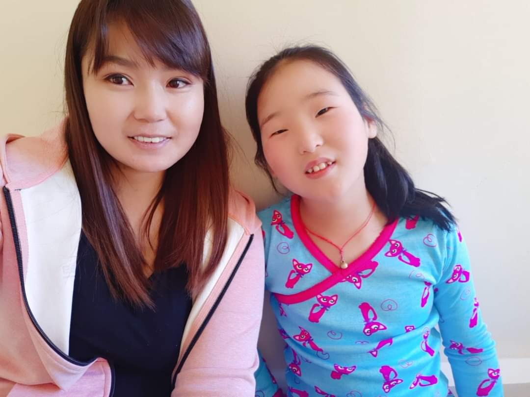 zaya poses with social worker before heart surgery