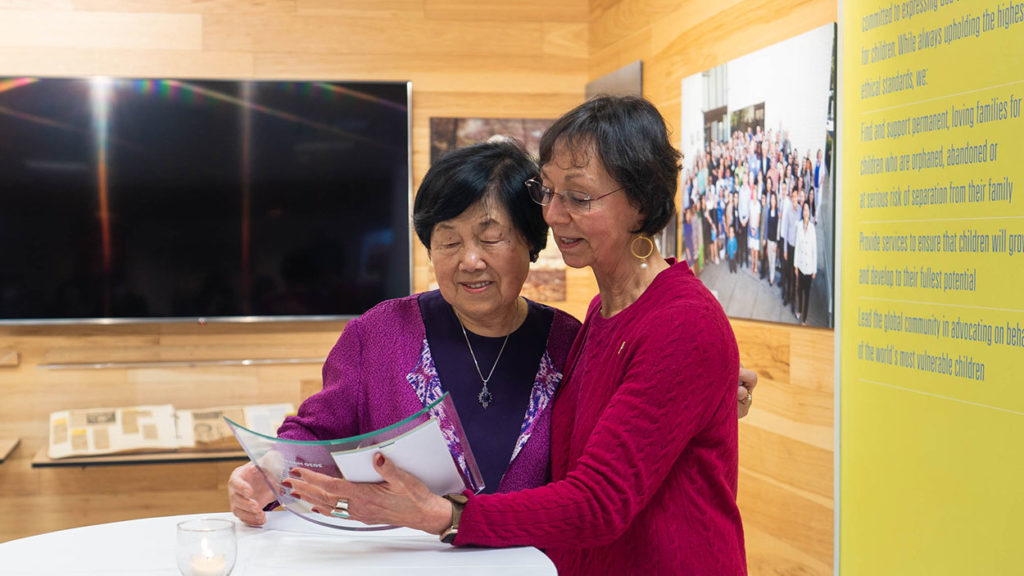 holt board member Margaret Fitch-Hauser and Nancy Kim holding harry holt award