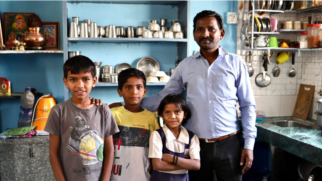 father standing with kids