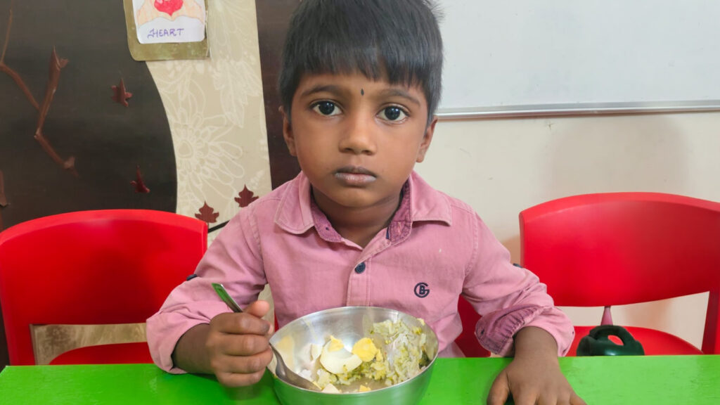 Little boy with food looking at the camera, sad