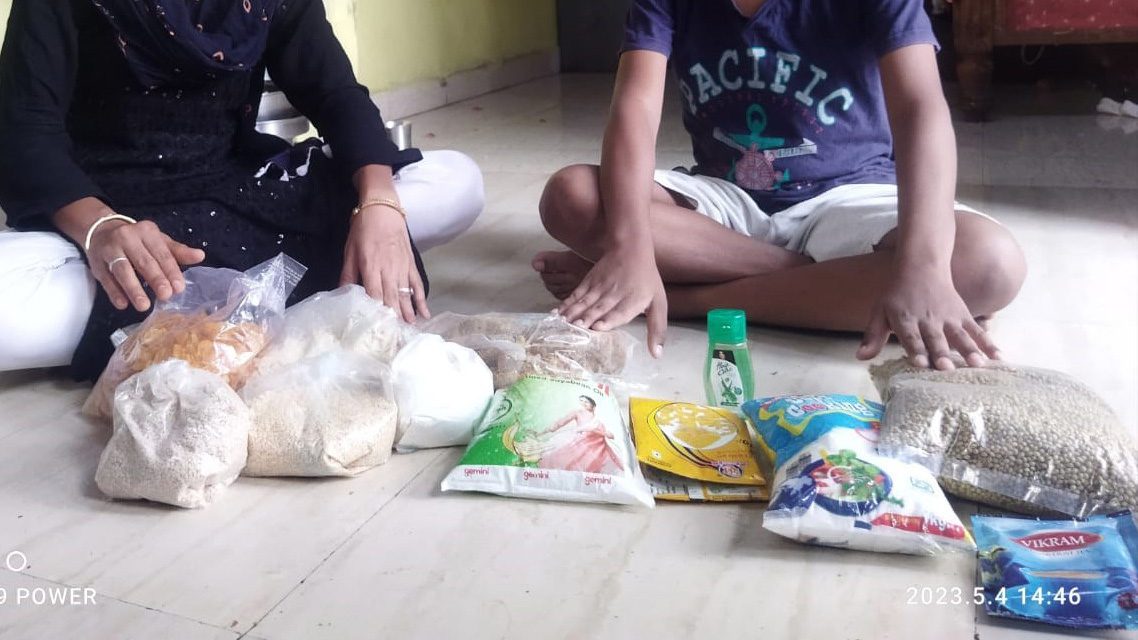 Collection of food spread out in front of mother and son