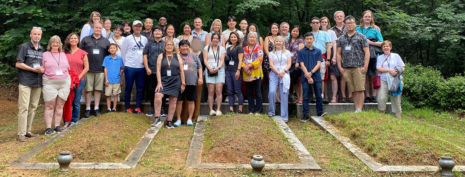 2023 Holt Korea Heritage Tour group at Harry, Bertha and Molly Holt's gravesites at Ilsan
