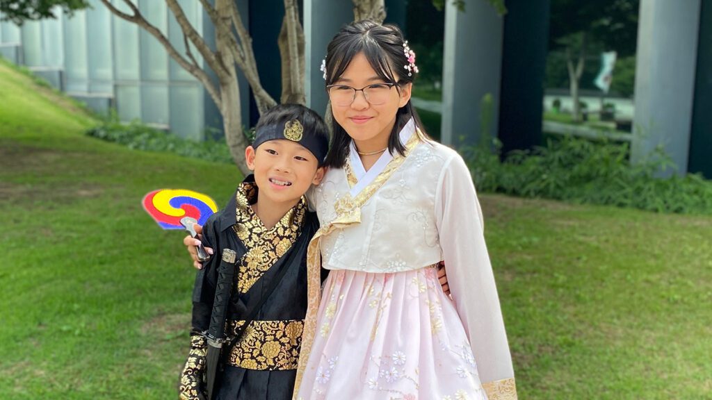 Korean adoptee sister and brother on Holt's 2023 Korea Heritage Tour dressed in traditional Korean dress