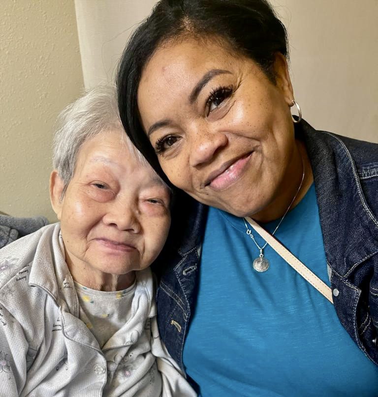 Mother and daughter smile at the camera