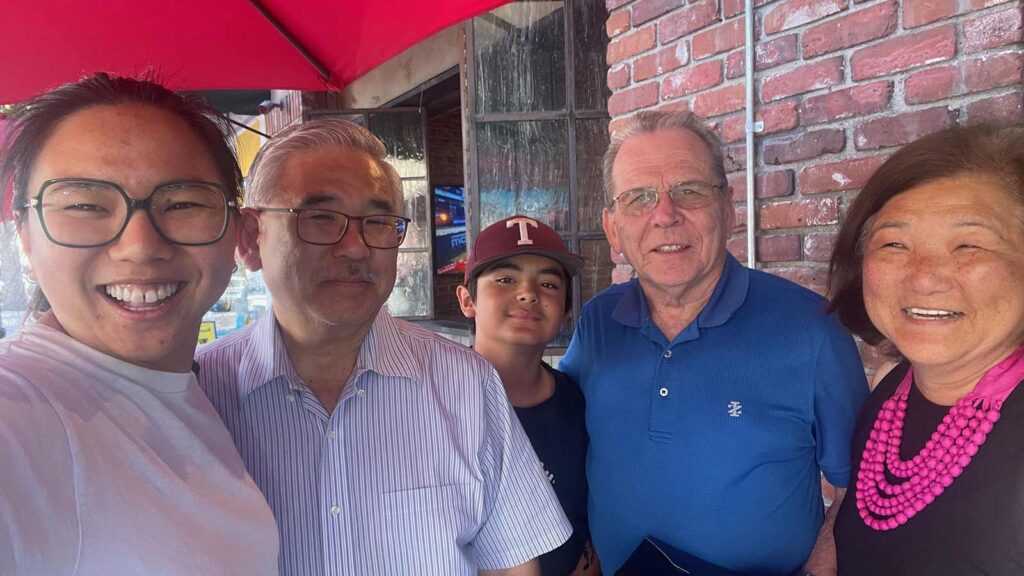 Katelyn Dixon with her family on an outdoor patio