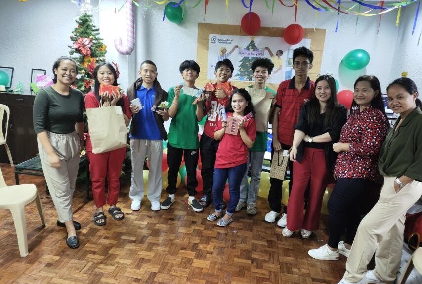Group of people in festive attire gather to smile at camera