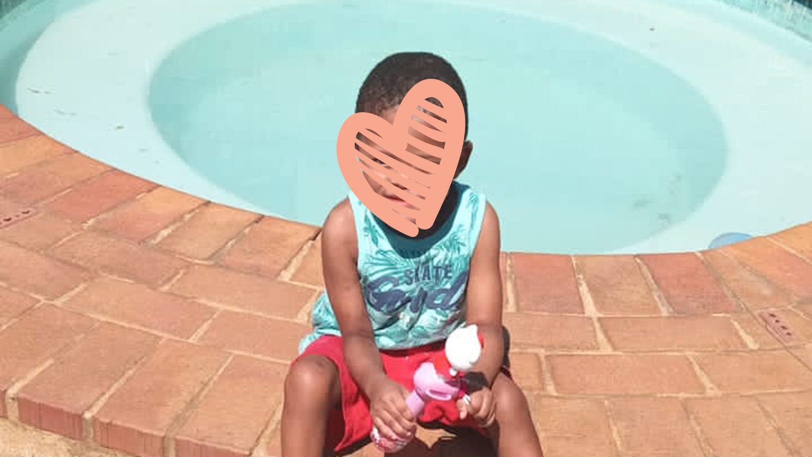 Baxter needs a family. He is sitting here by a pool.