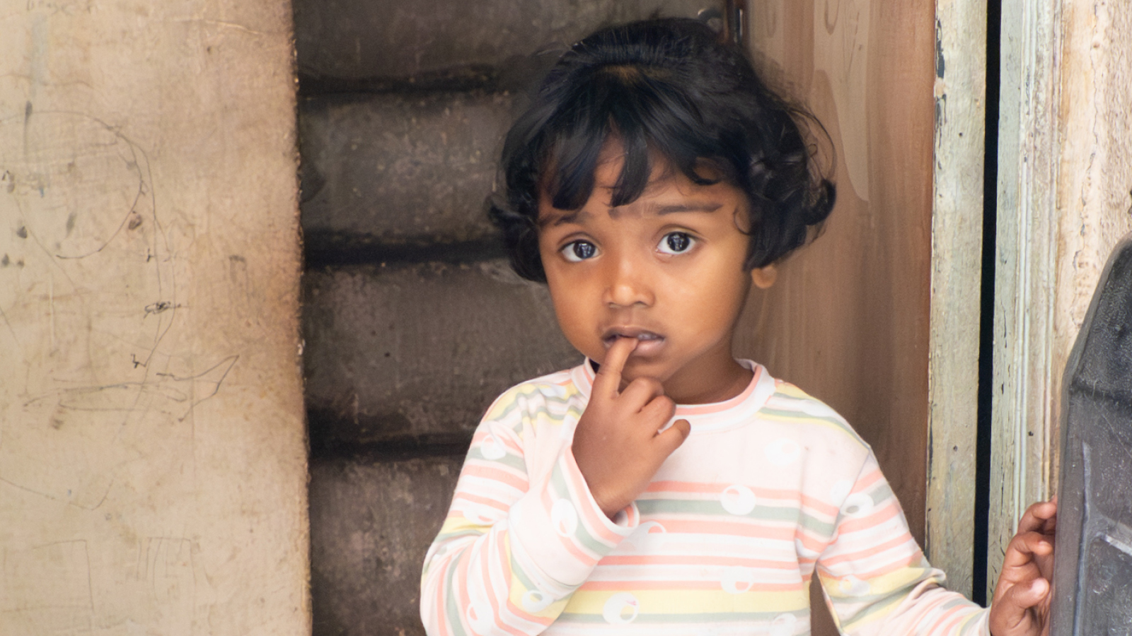 Little girl standing in a stairwell in India