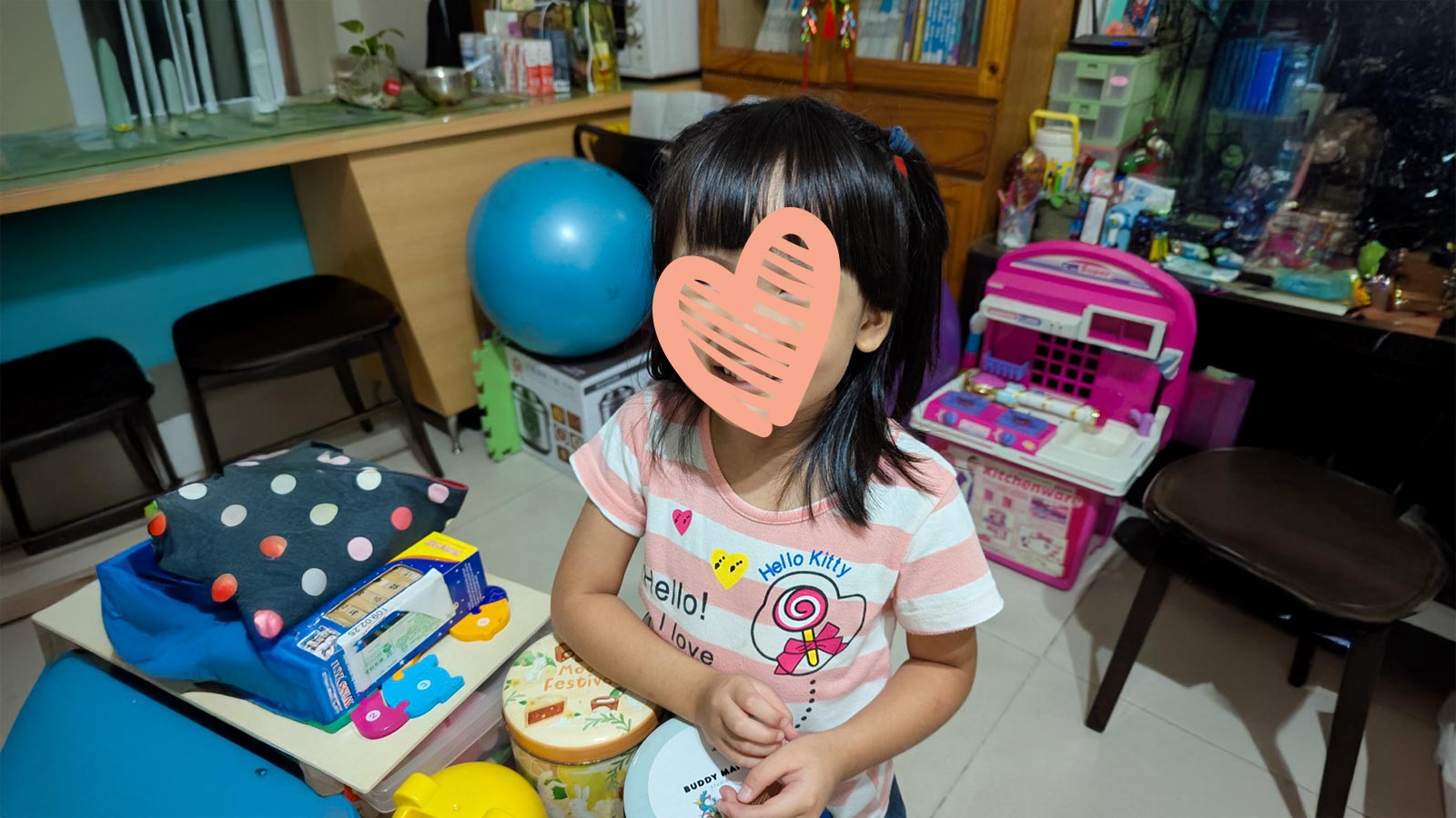 a waiting child holds a toy