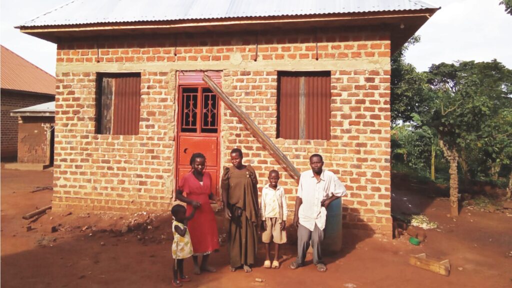 Abebe and his family stand outside their warm, safe home