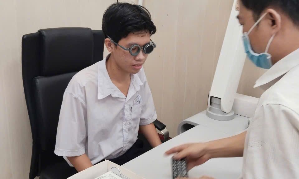teenage boy receiving an eye exam by an eye doctor in Vietnam