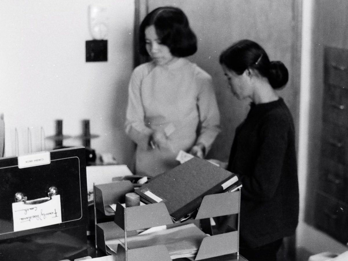 Two Holt workers organize child adoption records in Saigon for evacuation