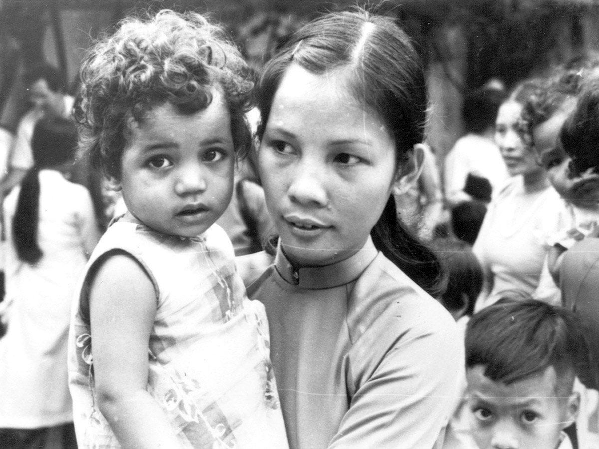 A foster mother holds her her foster child in Saigon, Vietnam in 1975.