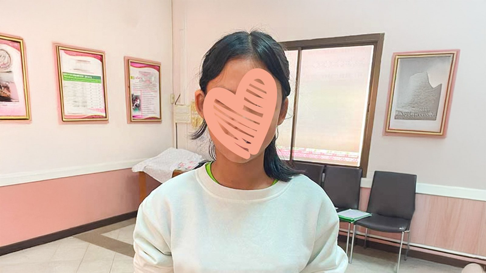 A waiting child named Kayla needs a family. She smiles with a heart over her face, ready for an adoptive family.