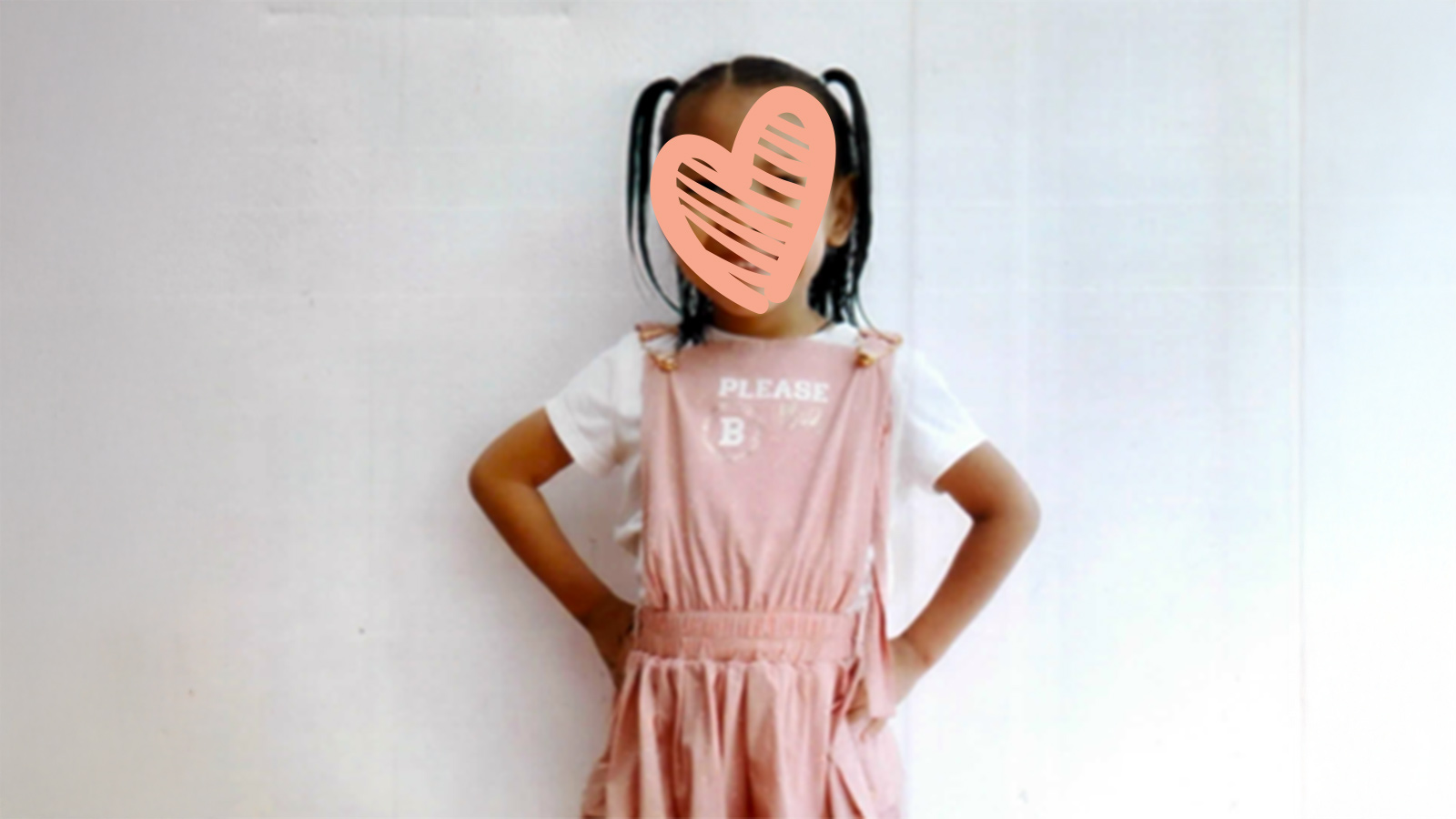 a waiting child waits for a family with a heart over her face