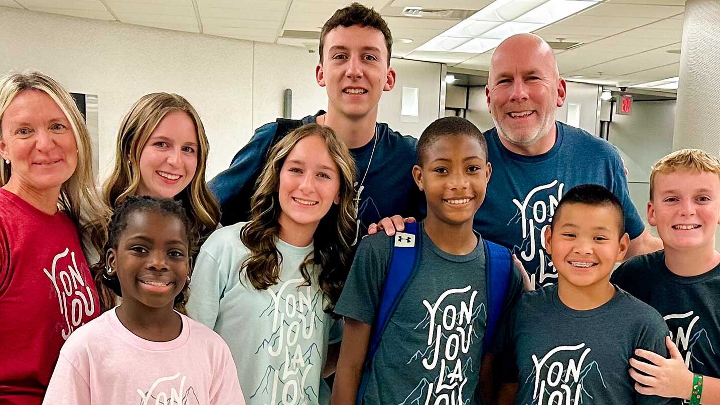 a child from haiti is united with his adoptive family after a long adoption journey